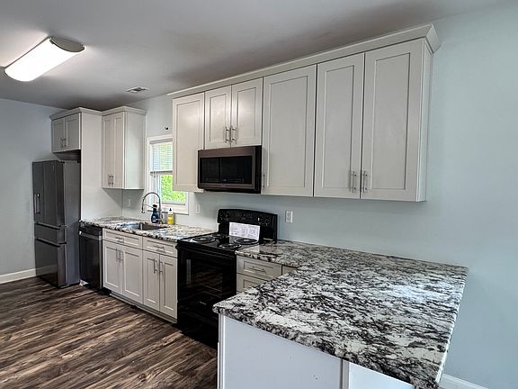 Kitchen with stainless steel refrigerator and dishwasher. 42 inch cabinets.