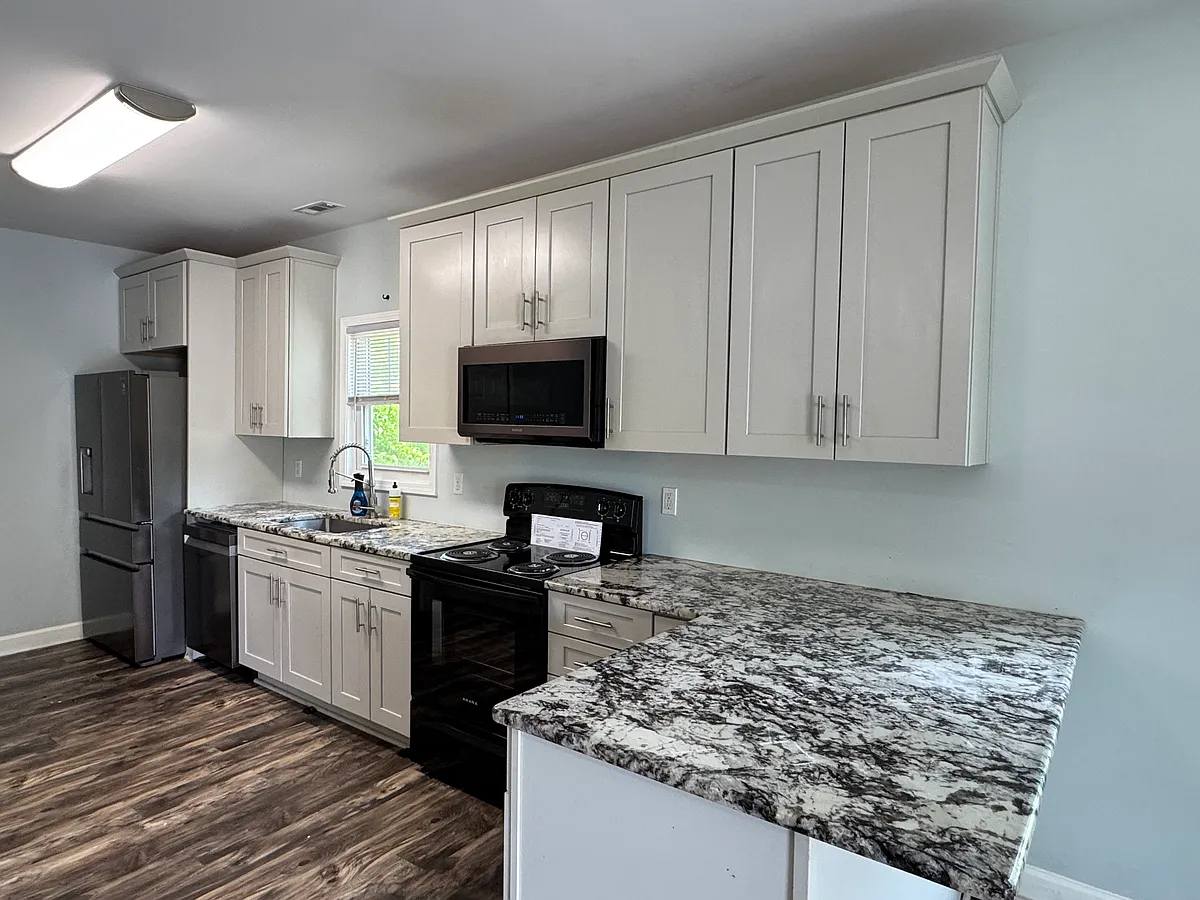 Kitchen with stainless steel refrigerator and dishwasher. 42 inch cabinets. - 1406 W Club Blvd #B