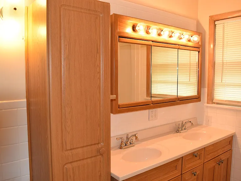 Full bath with tub, shower and double sinks. Linen closet is so handy.