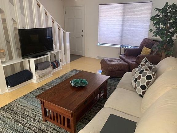 Living room, front door, stairs up to two bedrooms and full bath.