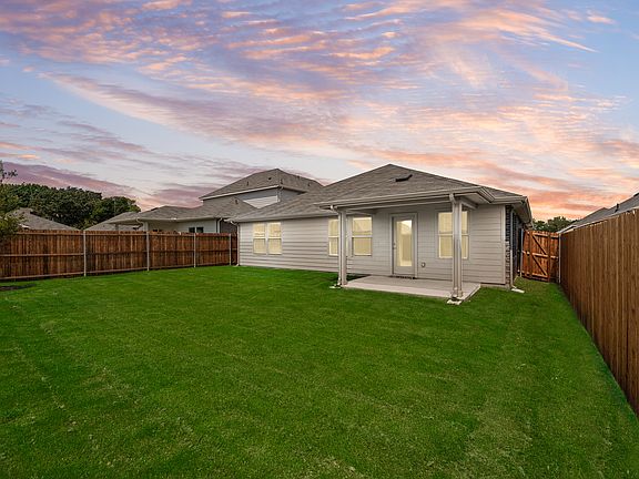 Fully fenced backyard with covered patio