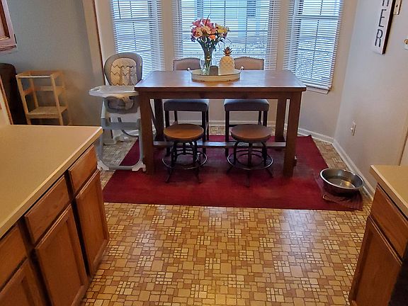 Large breakfast table area near windows in equipped kitchen