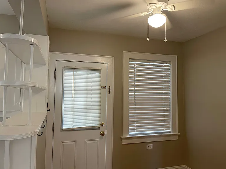 Breakfast nook between kitchen and living room viewed from bedroom entry with access to bedroom kitchen living room and rear deck