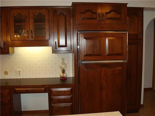 Built-in desk and china with raised panel refigerator
