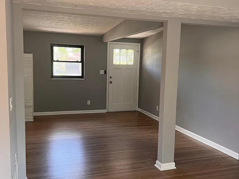 View from dining room to the front door also showing part of the living room.