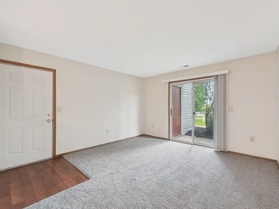 Dooley's Orchard apartment unit showing the living area and patio door entrance.