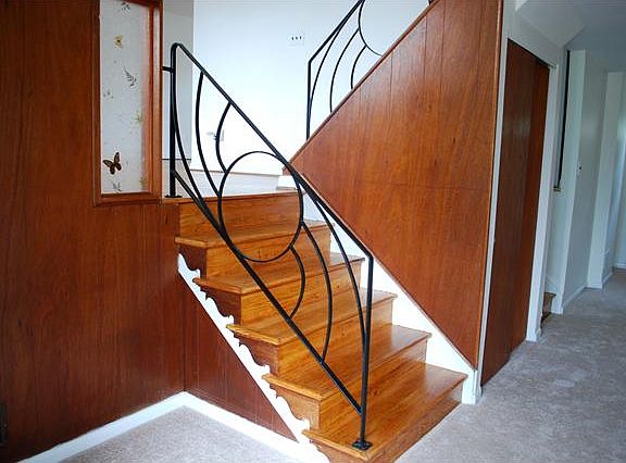 Foyer entry w/ new carpet & exposed wood stairs