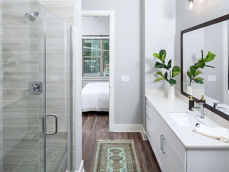 Modern Bathroom with Spacious Vanity, Frameless Shower, and Wood-Style Flooring