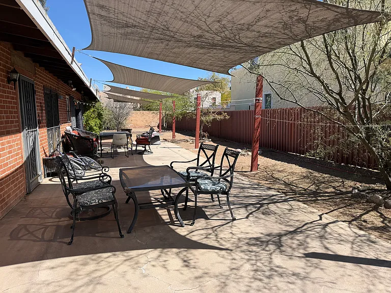 Backyard shared by both sides, shade canopies help keep house cool and provide outdoor space to enjoy..