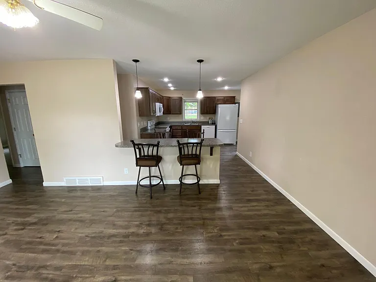 Living Room view through bar and into kitchen.
