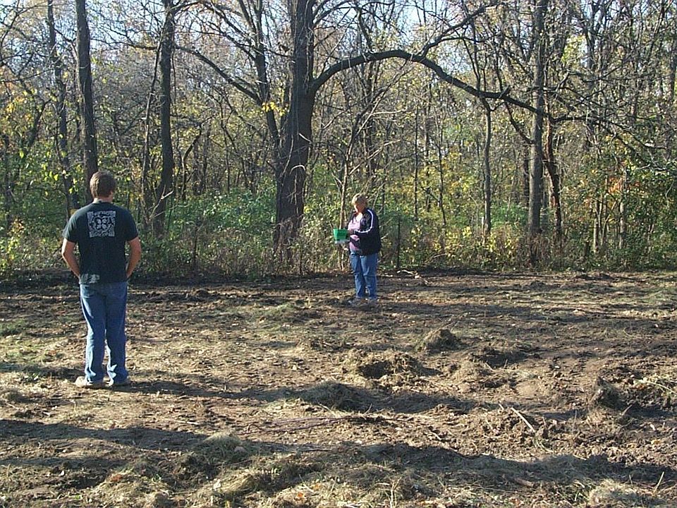 Spreading grass seed after house was removed