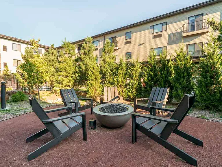 Cozy fire pit seating offers a perfect spot to unwind and connect with neighbors.