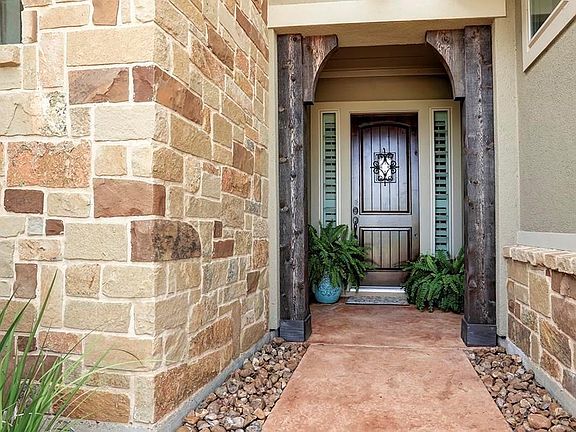 This home explodes with charm the minute you are greeted at the front door   stone beds lace the stained concrete walkway, frame