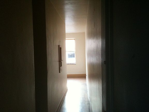 Entry hall to apartment. Living room on windows, bedroom in the center and kitchen faces hallway.
