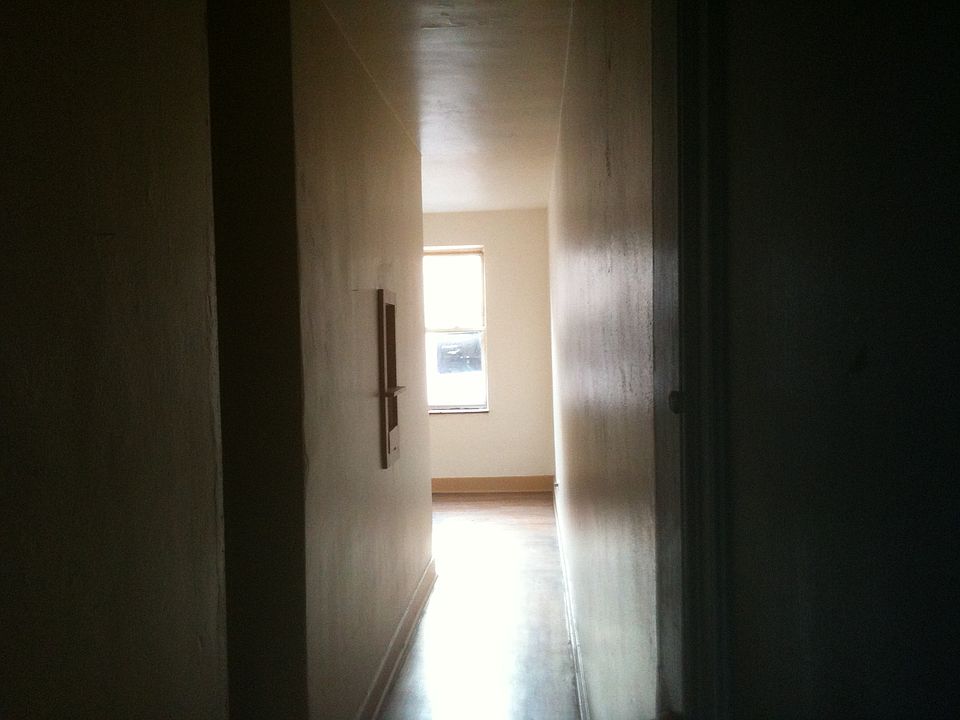 Entry hall to apartment. Living room on windows, bedroom in the center and kitchen faces hallway.