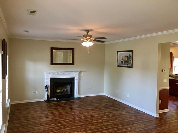 Large, open great room with wood-burning fireplace.
