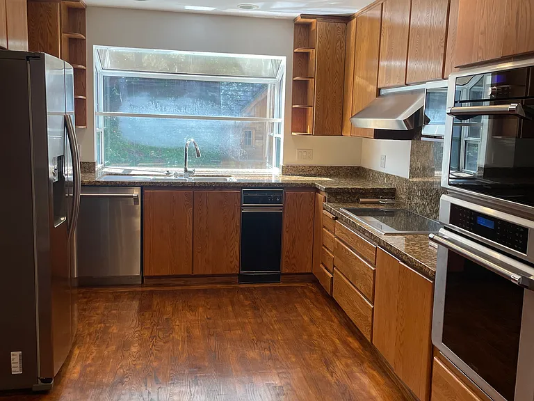 Kitchen with stainless steel appliances, double ovens, and study/work area