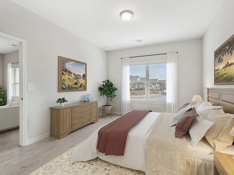 Primary Bedroom with king size bed and large window letting in nice natural light.