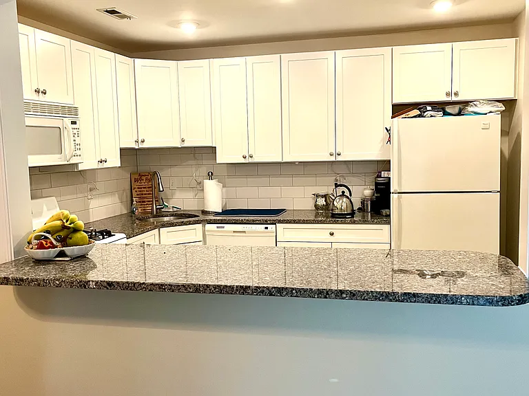 Granite counter extended to allow for extra seating in dining room
