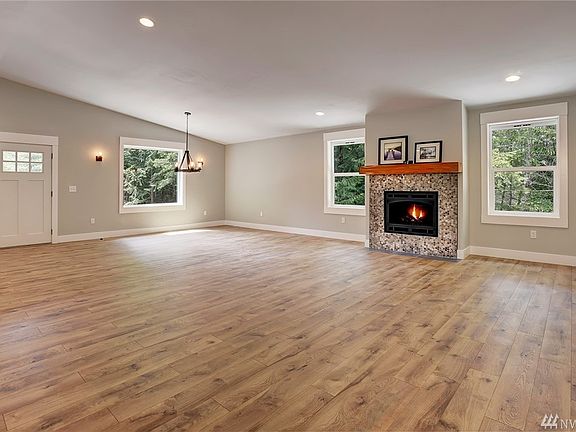 Look at the space in this open floor plan - showcasing the propane fireplace with old growth cedar mantle from the property! Whole house fan with programmable timer.