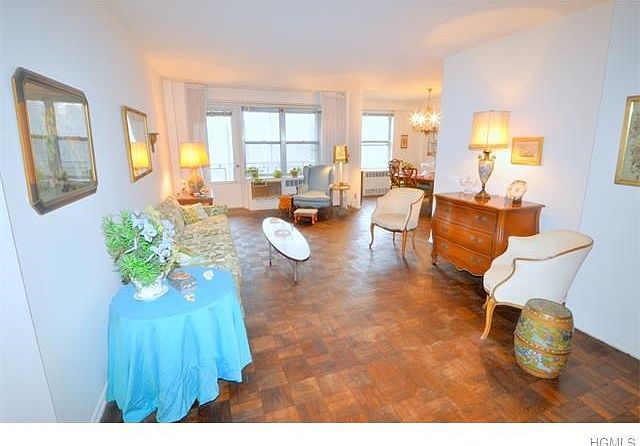 Large Sunny living room opens to the Dining Room.  There is a door leading to the balcony overlooking Garth Park and Playground.  The room has parquet floors, a large walk-in closet and is 30'-2" x 12'-4".