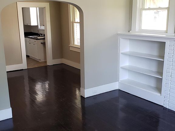 Front LR with hardwood floors, built in book shelves and fire place (non-functioning)