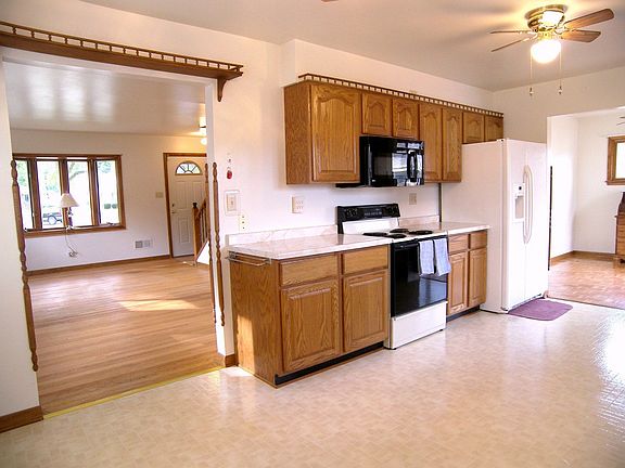Eat-in kitchen open to both living room and dining room/den.