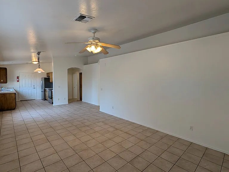 Bright and spacious open-concept living area featuring brand-new interior paint and low-maintenance tile flooring.