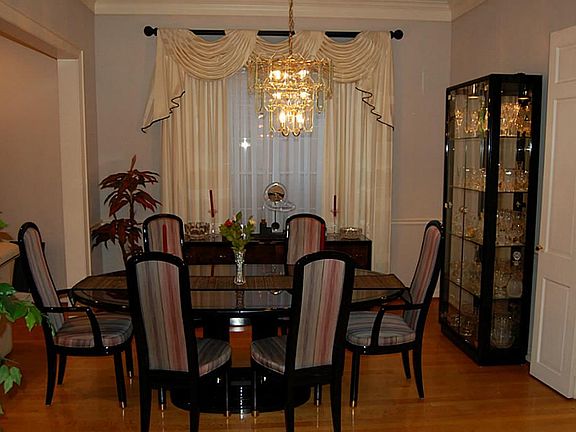 Formal Dining with hardwood floors,decorative railing