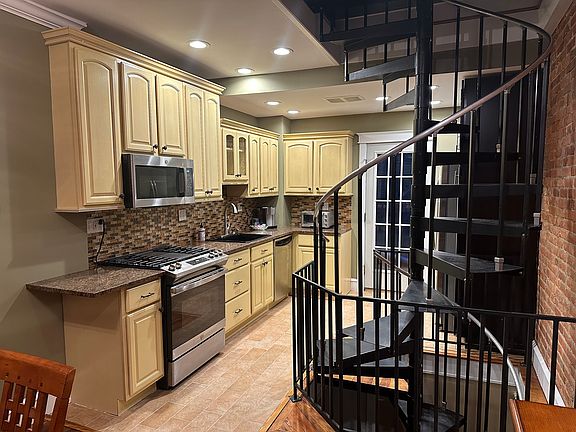 Rear Kitchen with view of spiral staircase, access to rear patio (11 x 8)