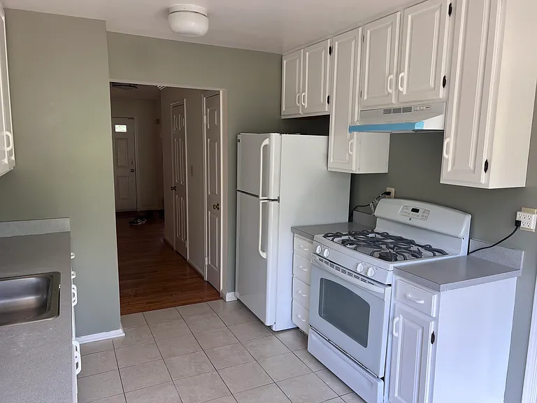 Kitchen with new hood and freshly painted cabinets