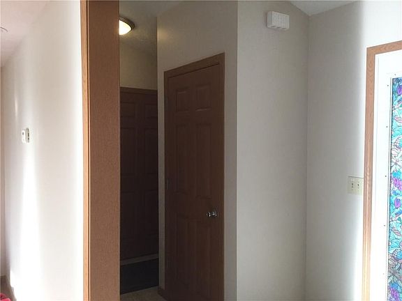 Large coat closet in entryway with access to basement.