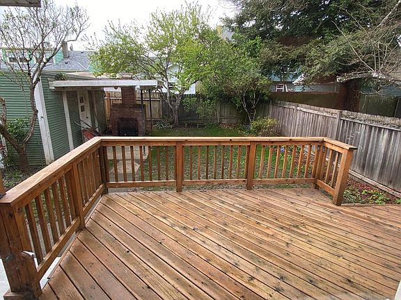 Deck off kitchen. Fenced back yard. Covered patio with outdoor fireplace.