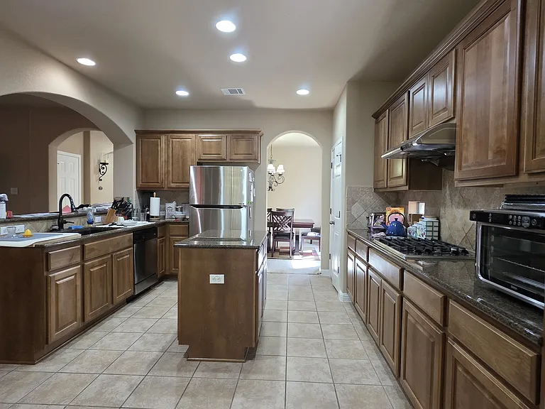 Kitchen is very spacious with gas cooktop and island. Tenant's own fridge is in place currently (available for sale to next tenant).