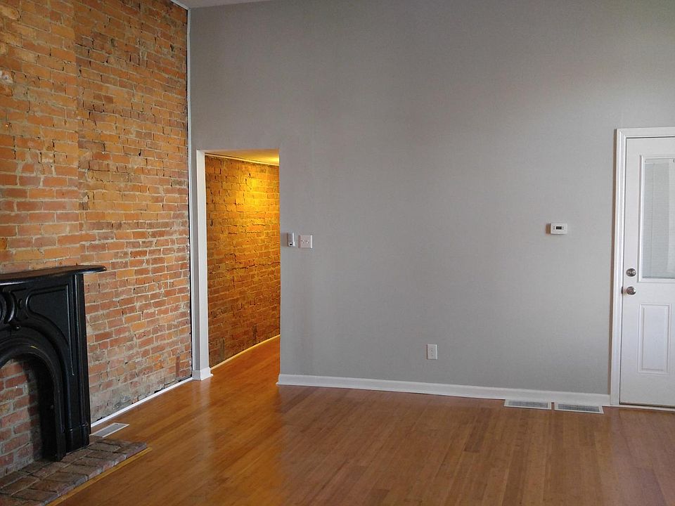 Entry door into apartment. Also showing hall that leads to kitchen and bathroom.