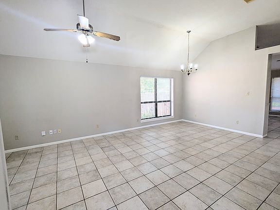 Elegant dining space with high ceilings, elegant lighting, and easy flow to the kitchen.