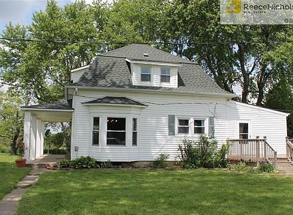 Vinyl Siding.  Most of the windows have been replaced.  Spacious Front Porch and Wrap-Around Deck Overlooking an Above Ground Pool.