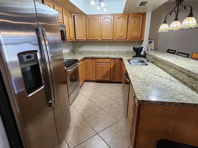 Modern kitchen with granite counter tops and modern appliances.