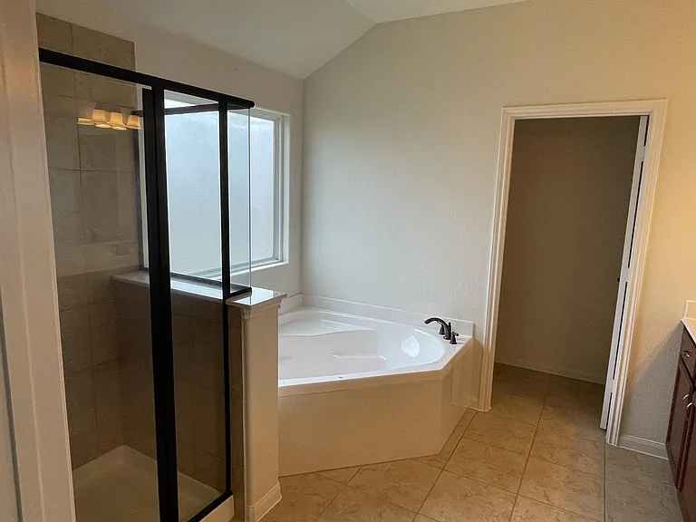 Primary bathroom shower + oversized garden tub to relax in!