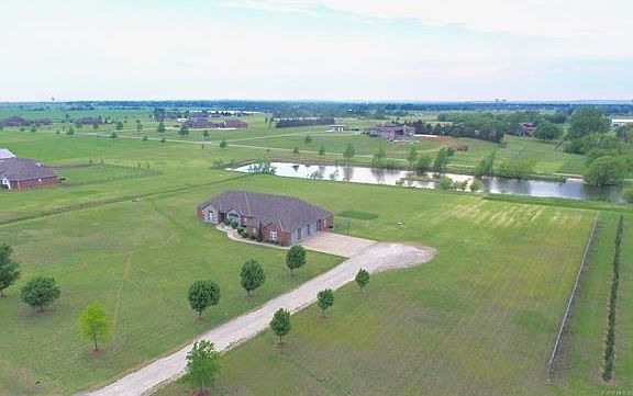5 acres incl. private fishing pond shared with 2 adjacent neighbors.  12 min. drive to downtown Bartlesville, OK.