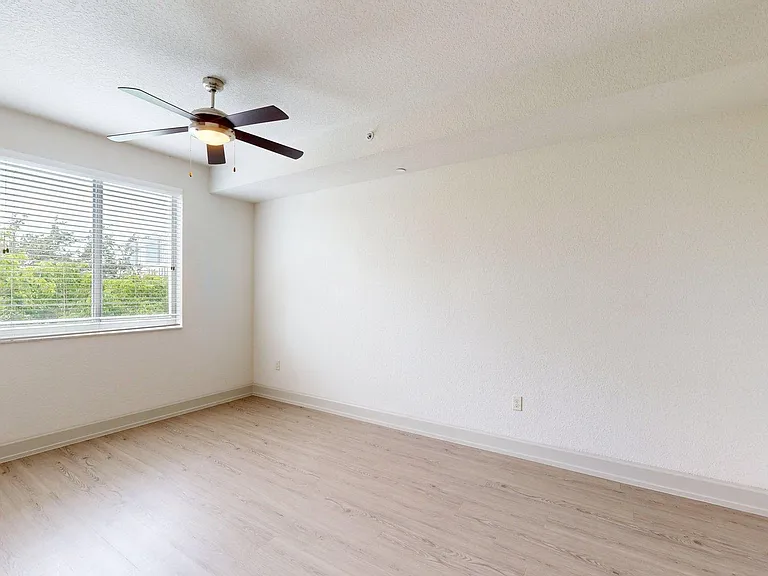 Apartment bedroom with wood style floor.