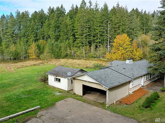 Home with attached carport and outbuilding. Lovely secluded lot.