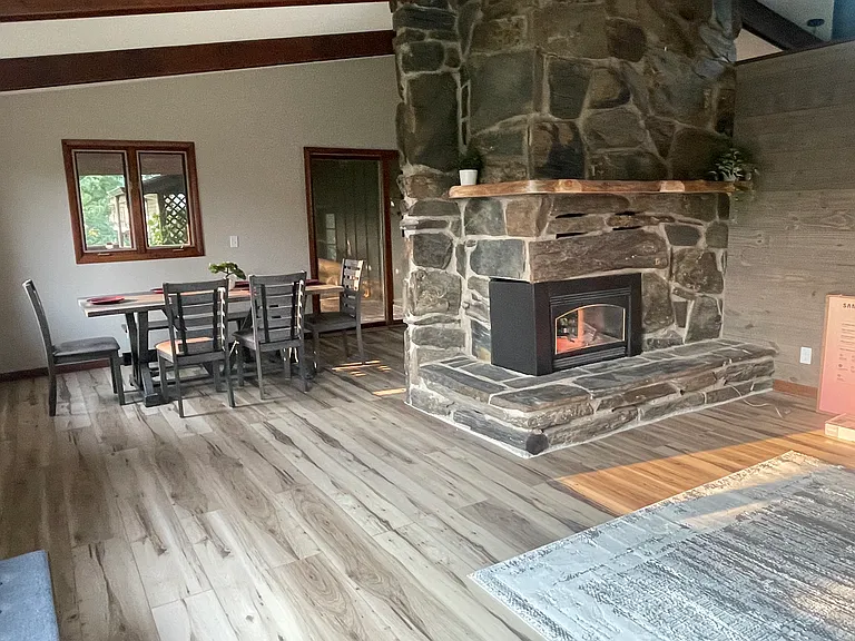 Living and dining areas open to each other, large flagstone fireplace.