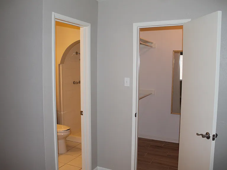Master bedroom walk-in closet and full bathroom.