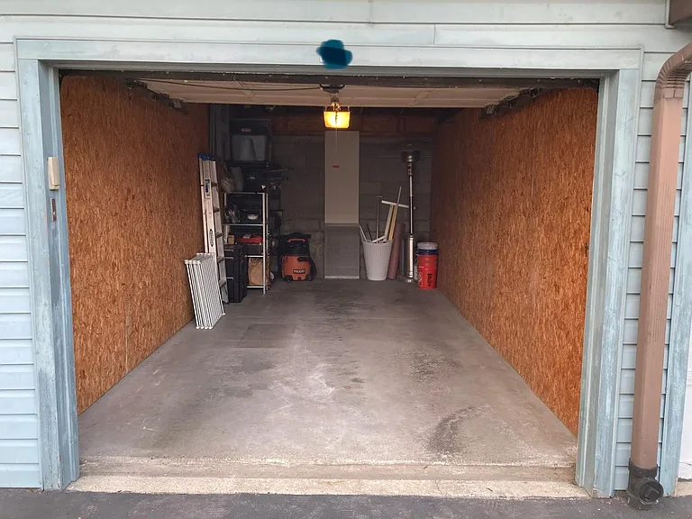 Ample room for storage on shelving unit, suspended shelves, and bike storage.