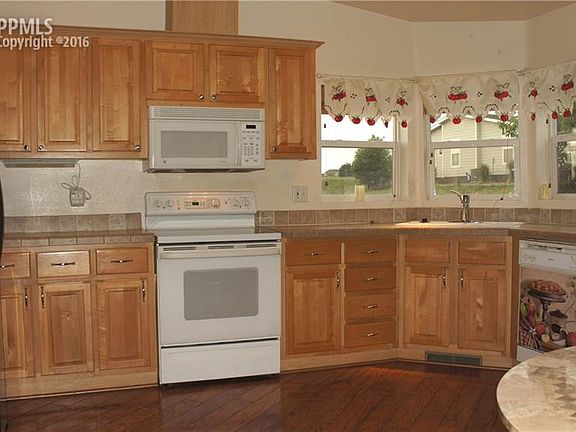 Nice open kitchen with lots of counter space, tile counter tops, and all applian