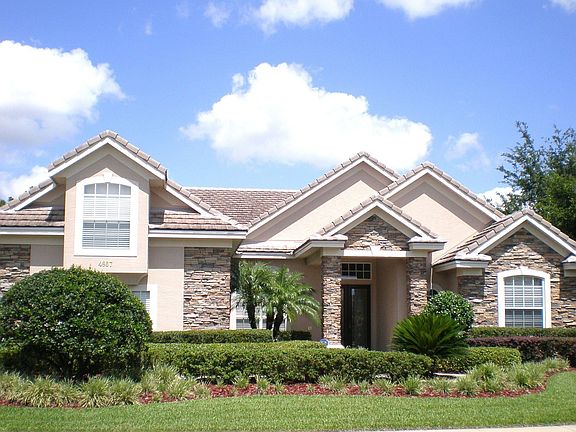 Stone front, Tile Roof, 3 car side entry Garage
