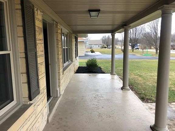 Covered front porch ready for a rocking chair.