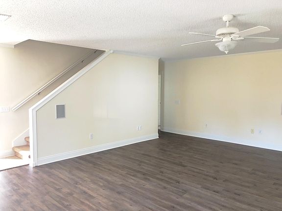 Living room with stairs that lead to upstairs suite