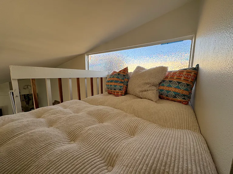 Loft couch that is opened up to become a full size bed for extra people.